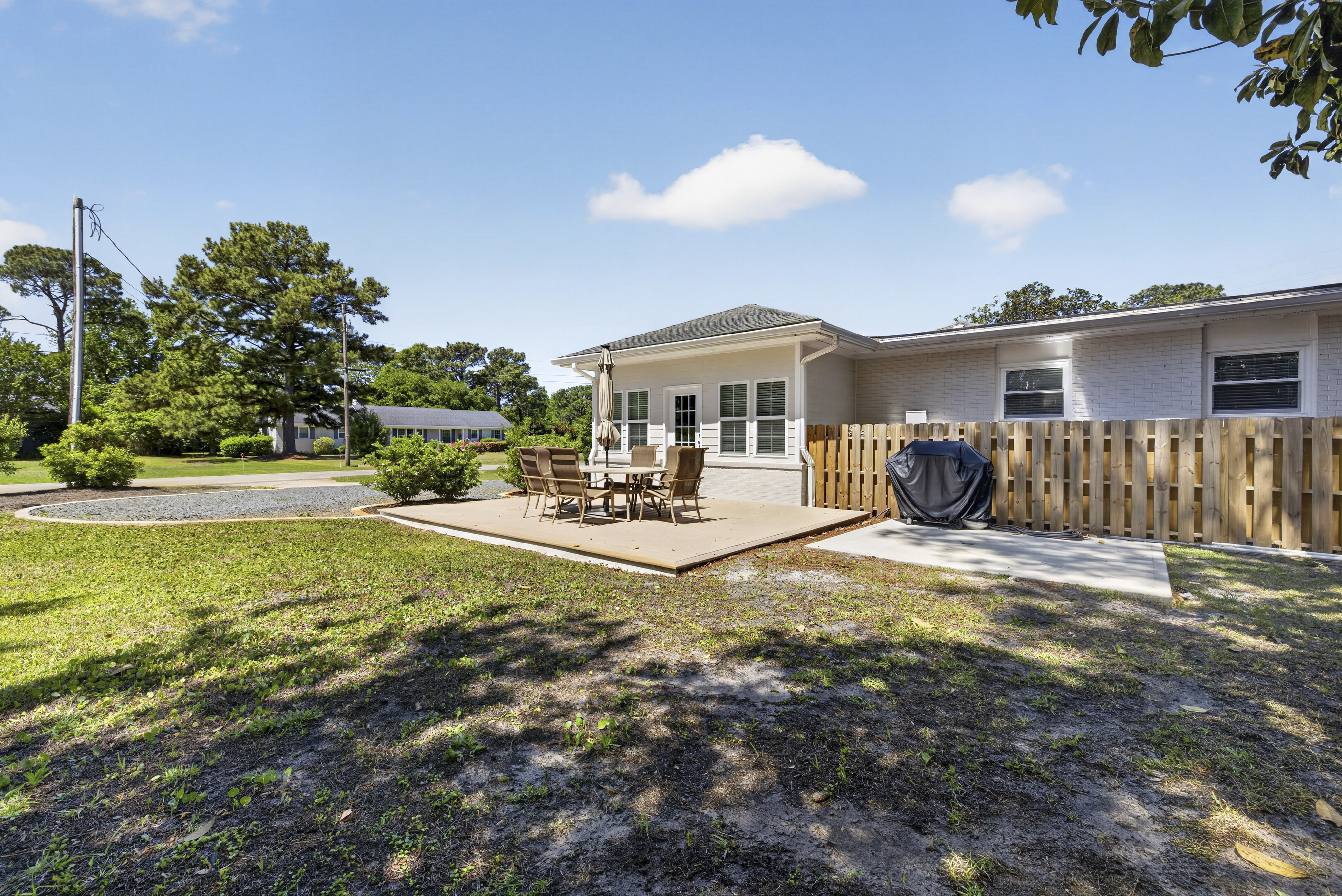 Back patio with outdoor dining and BBQ grill